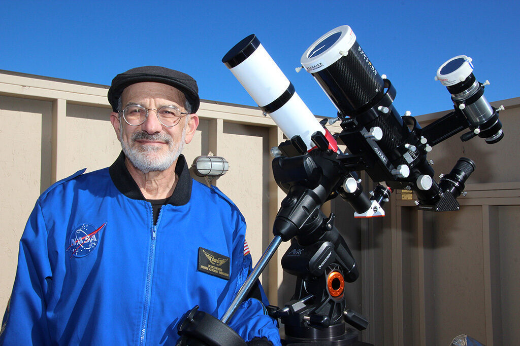 Rick Fienberg stannding with his telescope