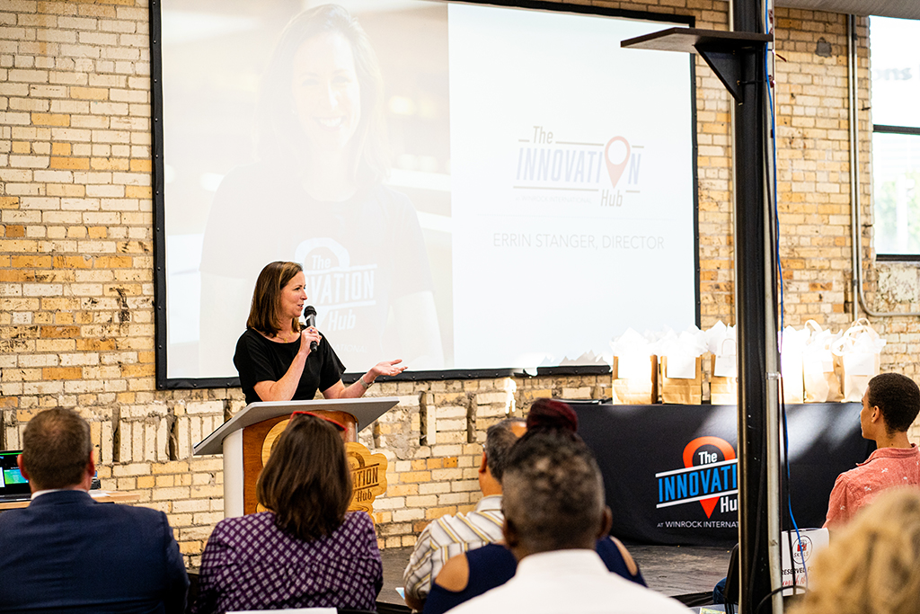 woman speaking in front of a crowd